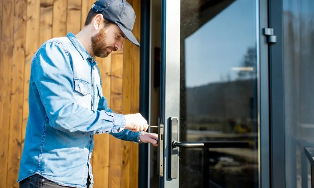 a professional locksmith using a tool to repair door lock