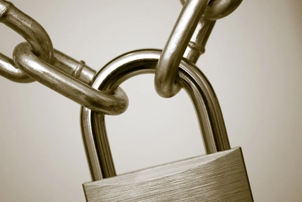 Close-up of metal padlock securing chain