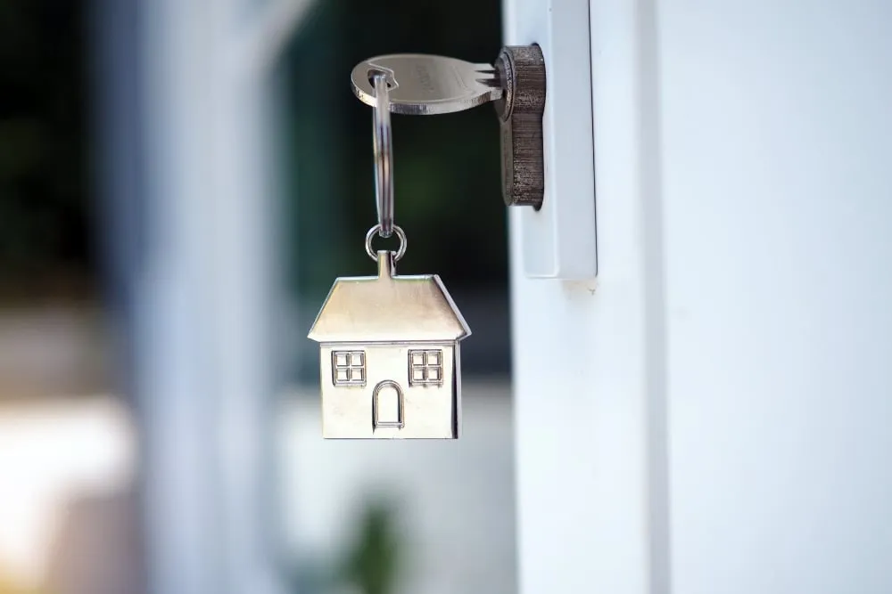 House-shaped key hanging from door lock