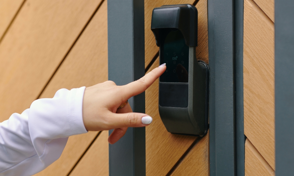 Hand pressing digital smart lock on wooden door